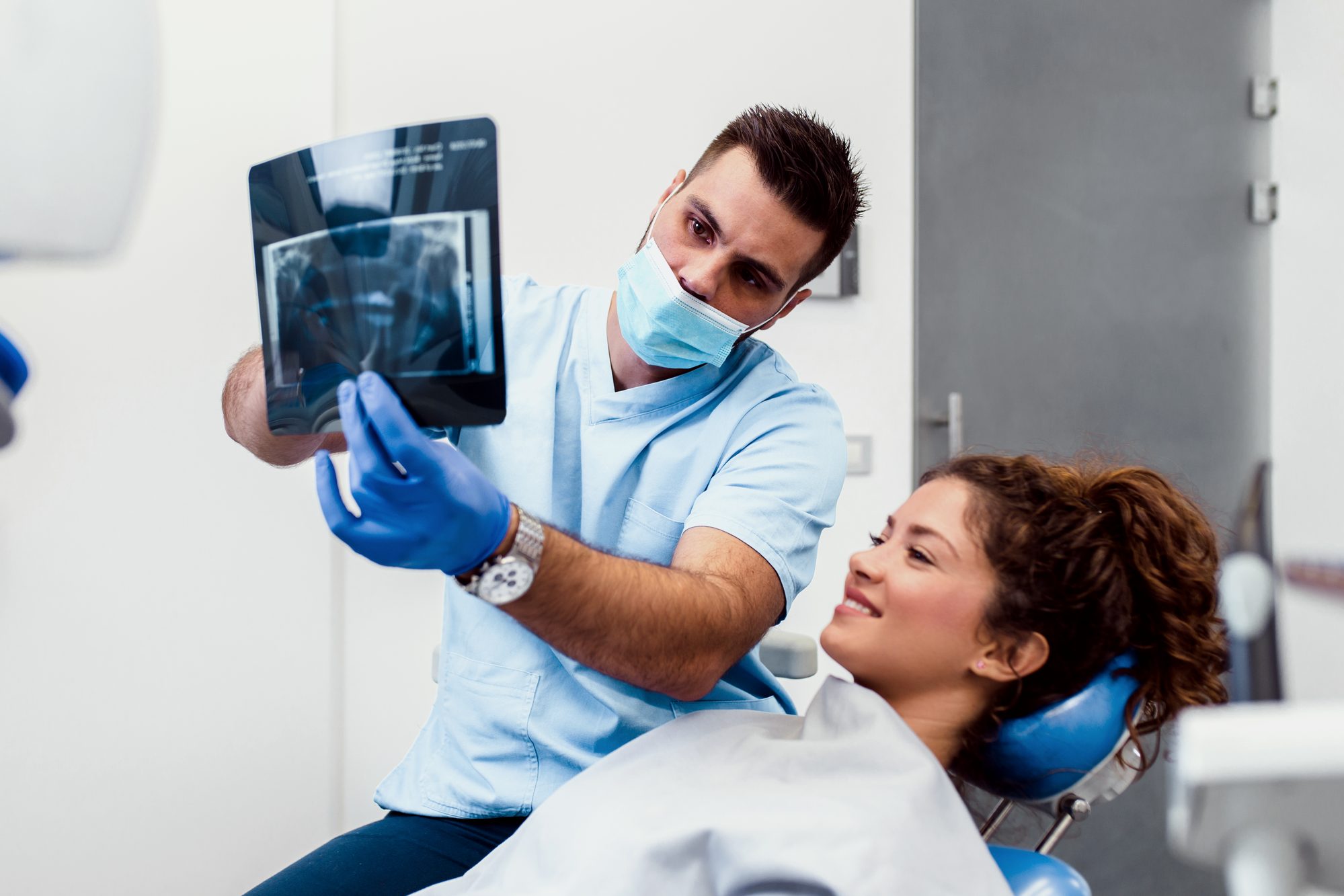 Dentist consulting with patient