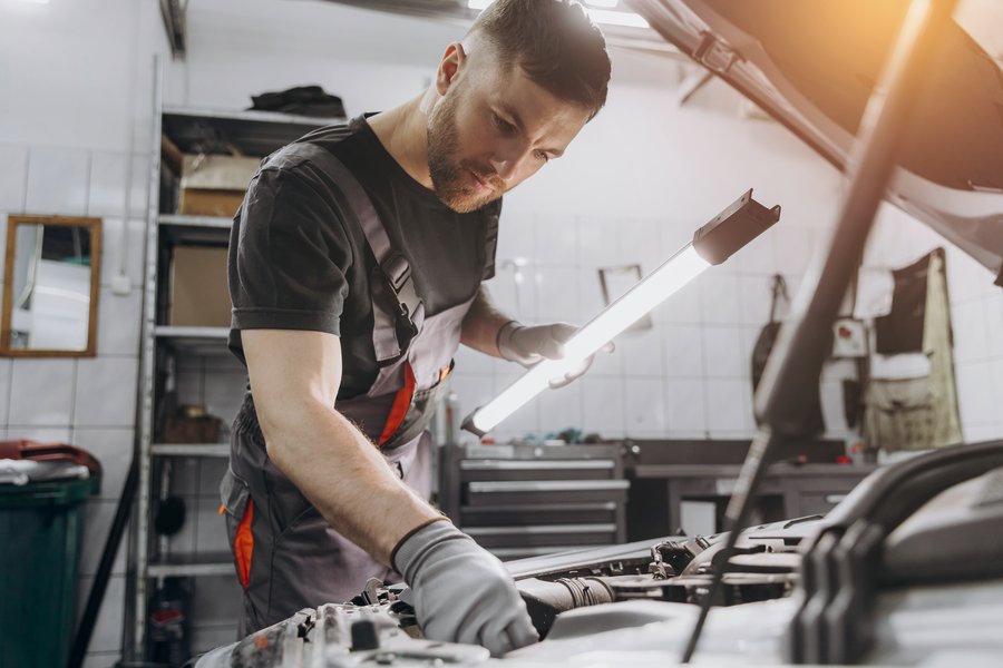 Auto repair technician working on a vehicle, representing automotive and local retail businesses